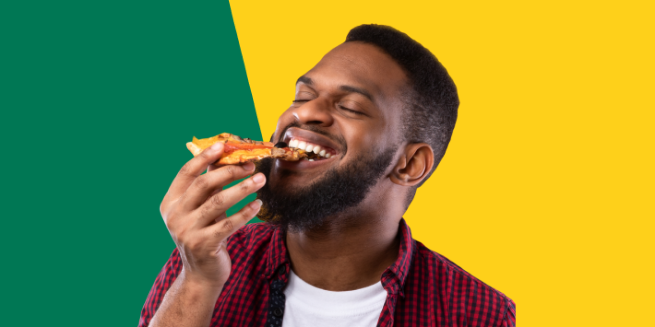 A person eating a slice of pizza.